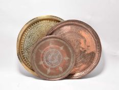 Three Islamic incised metal circular tray table tops