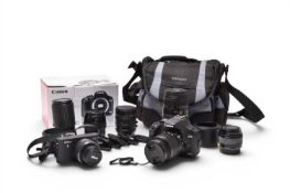 A group of photographic equipment including a Canon EOS 500D digital SLR camera and others