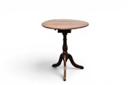 A 19th century oak tilt-top tripod occasional table