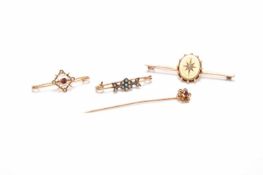 Three brooches and a stick pin