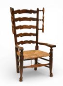 A 19th century ash wood rush seated wavy ladder-back armchair
