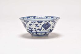 A near pair of Chinese blue and white bowls and another larger