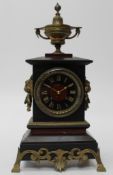 A late 19th century ' black slate', rouge marble and ormulu mounted mantle clock. The