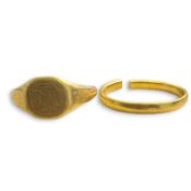 Two rings, one in 22ct gold, the other in 18ct gold. Comprising a 22ct gold band ring and an 18ct