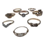 A collection of eight 9ct gold and precious metal dress rings. Comprising a 9ct gold diamond set