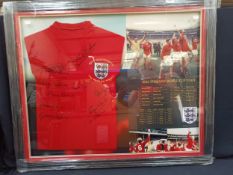 A framed and glazed shirt and montage, England "1966 World Cup Team", signed by ten. Measuring