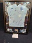 A framed and glazed shirt and montage, England "2014 World Cup Brazil", signed by thirteen.