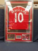 A framed and glazed shirt and montage, Dennis Bergkamp, signed. Measuring approx. 100cm x 65cm.