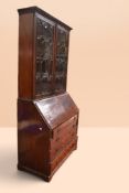 George III mahogany bureau bookcase with three internal bookshelves behind two glazed panelled doors