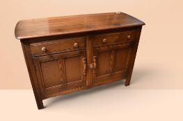 Ercol dining room dresser with plate rack of two shelves and two single frieze drawers above two