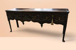 Queen Anne oak three drawer dresser base with apron detail of ornate finials to drawers with brass