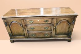 20th century solid oak dresser base in the George III style with three central drawers flanked on