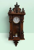 A 19th century veneered Vienna wall clock with enamel dial. In need of attention.