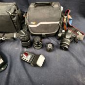 Canon AV-1 camera with lenses and accessories in a carrying case, together with a Canon EOS 500D