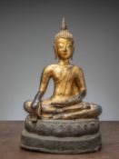 (R) A GILT BRONZE FIGURE OF BUDDHA ON A LATER INSCRIBED BASE, THAILAND AYUTTHYA (1600 - 1650)