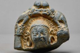STONE HEAD OF A BUDDHA WITH ATTENDANT ELEPHANTS, KASHMIR REGION, 4TH–5TH CENTURY