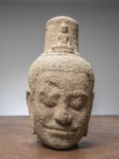 (R) AN EXQUISITE KHMER SANDSTONE BUDDHIST HEAD, CAMBODIA, 12TH CENTURY