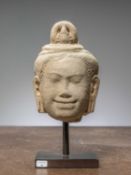 (R) A KHMER STONE HEAD, SANDSTONE, ANGKOR PERIOD, KHMER EMPIRE, 12TH TO 13TH CENTURY