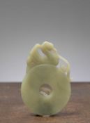 (R) A JADE CELADON BI-DISC WITH PHOENIX, CHINA, 18TH CENTURY