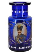 A QAJAR ENAMELED AND GILT COBALT-BLUE GLASS HOOKAH BASE (QALYAN) DEPICTING SHAHANSHAH NASER AL-DIN S