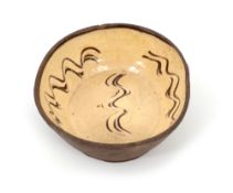 A Fremington (Devon) slipware dish, 19th century, with deep sloping sides, decorated with sgraffito 