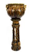 A large Majolica jardinière and stand, 19th century, possibly Clement Massier, modelled in the Aesth