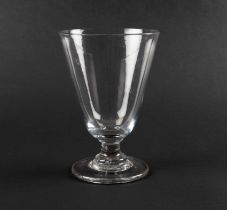A large toasting glass or goblet, c.1760, the deep round funnel bowl raised on a short plain stem an