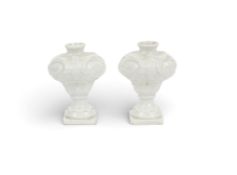 A pair of miniature Vienna vases, mid 18th century, of rococo baluster form, moulded with foliate sc