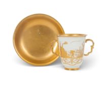 A Meissen hausmaler two-handled cup and saucer, c.1725-30, decorated in Augsburg with gilt scenes of