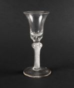 A wine glass, c.1760, the bell bowl with a solid base enclosing two rows of tears, raised on an airt