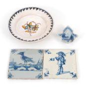 Two Delft tiles, c.1700, one painted with a soldier, the other with a bird, a small faïence dish pai