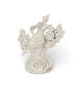 A Plymouth white-glazed figure of a female toper, c.1768-70, reclining amidst flowering bocage and l