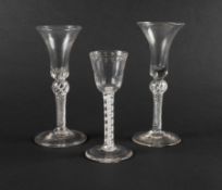 Three wine glasses, c.1750-60, two with waisted bell bowls and teared bases, raised on airtwist stem