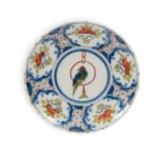 A delftware plate, c.1720, probably London, painted in a limited polychrome palette of red, blue and