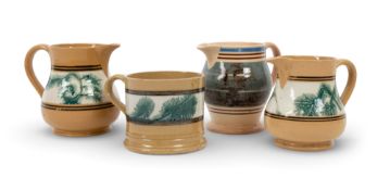 Three mocha ware jugs and a large mug, c.1820, two jugs and the mug decorated with a band of greenis