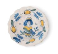 A small Delft Royal commemorative dish, c.1690-1700, the lobed form painted with a portrait of Queen