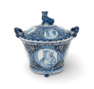 A rare Delft basket and cover, dated 1739, the flared form painted with panels of a woman with a cat