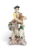 A large Bow figure of a piping shepherd, c.1760-65, after Meissen, holding his bagpipes and standing