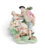 A Derby figure group of a shepherd and his companion, c.1780-90, she seated on a rocky outcrop with 