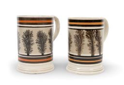 A pair of mocha ware mugs, early 19th century, decorated with vertical fronds of seaweed on a grey g