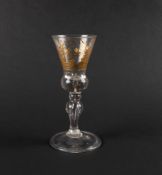 A rare Dutch-engraved light baluster glass, c.1750, the bell-shaped bowl with a solid teared base, e