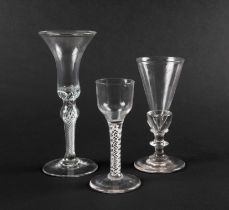 A small wine glass and two ale glasses, c.1760, the wine with an ogee bowl, one ale with a slender f