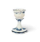 A Chantilly egg cup, c.1760, the six lobed form painted with small blue sprigs above a gadrooned ban
