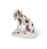 A good Bow figure of a Dismal Hound, c.1758, seated on an oval base and wearing a downcast expressio