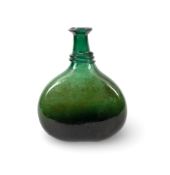 An early Persian glass saddle flask, 18th century, the rounded flattened form of a dark green hue, t