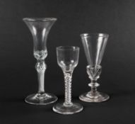 A small wine glass and two ale glasses, c.1760, the wine with an ogee bowl, one ale with a slender f