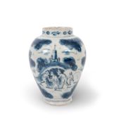 A Delft vase, c.1720, painted in blue with figures working in a field before a hill with a church an