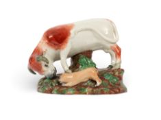 A Staffordshire figure group of a bull and dog, 1st half 19th century, the bull lowering his horns t