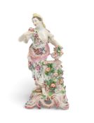 A Bow figure of Flora, c.1760-65, emblematic of Smell from a set of the Five Senses, holding a small