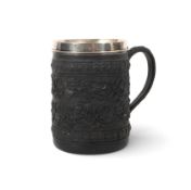 A silver-mounted Wedgwood black basalt mug, c.1807, densely moulded with continuous bands of oak fla